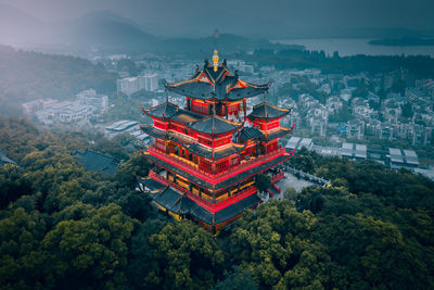 Panoramic view of temple and buildings against sky