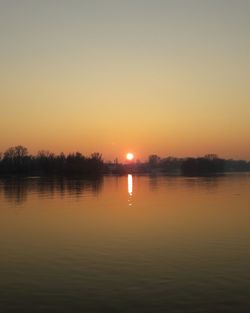 Scenic view of lake against romantic sky at sunset