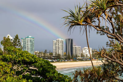 Scenic view of rainbow over city buildings