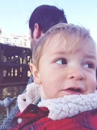 Close-up portrait of cute baby girl against sky