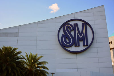 Low angle view of information sign against sky