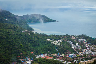 High angle view of trees and sea against sky