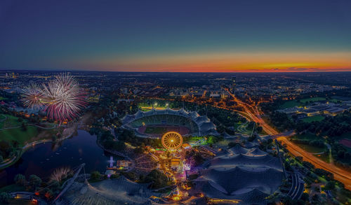 High angle view of city lit up at night