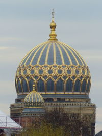 High section of temple against building