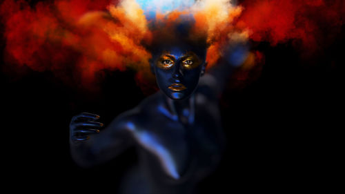 Portrait of naked woman with body paint against black background