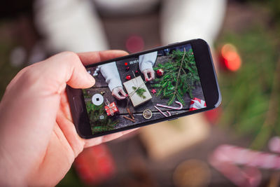 Close-up of hand holding mobile phone