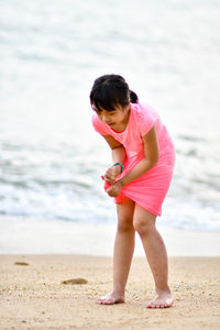 Girl squeezing dress at beach