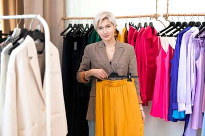 Woman choosing dress at store