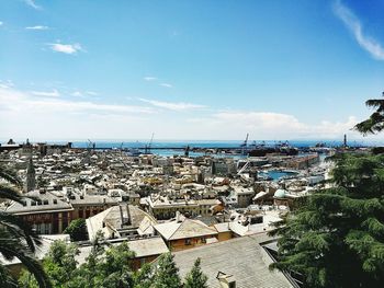 High angle view of townscape by sea against sky