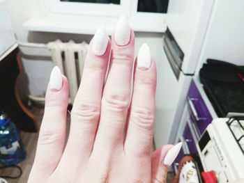 High angle view of woman feet on hand