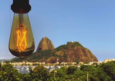 Low angle view of illuminated light against sky