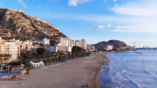 Panoramic view of sea and buildings against sky