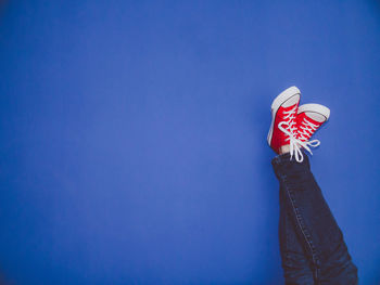 Low section of person on blue background