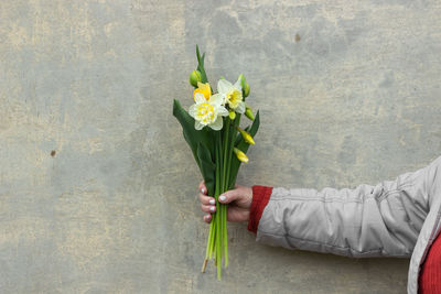 Low section of woman with bouquet