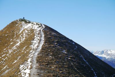 Snow covered mountain against clear blue sky