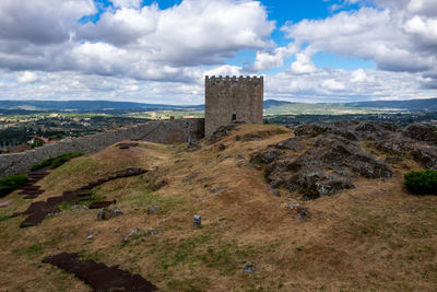 Old ruin building on landscape against sky