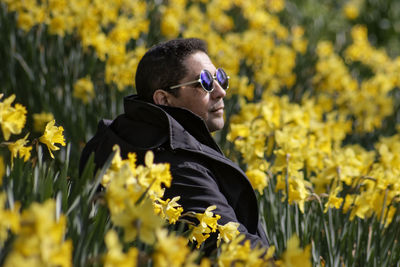 Close-up of man in yellow flowers