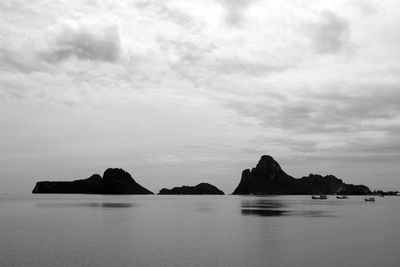 Scenic view of rocks in sea against sky