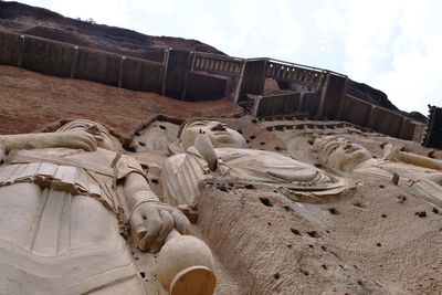 Sculpture of old building on beach