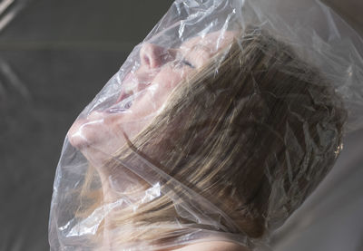 Close-up portrait of woman in plastic