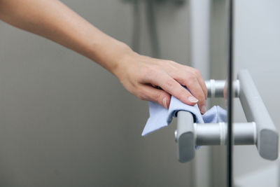 Close-up of woman cleaning door