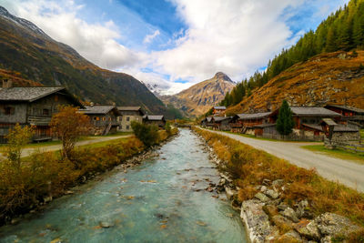 Scenic view of houses and mountains against sky