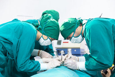 Doctors are treating patients in operating rooms equipped with modern medical equipment..