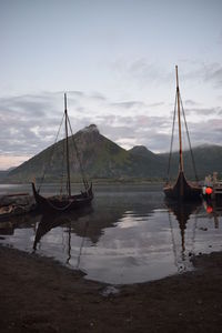 Boats moored on sea against sky