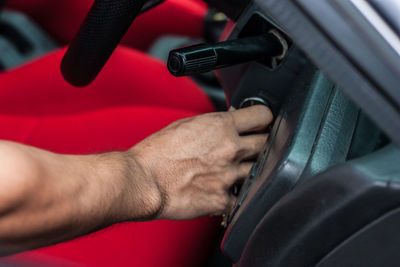Close-up of man holding cigarette in car