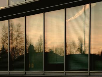 Close-up of window against sky at sunset