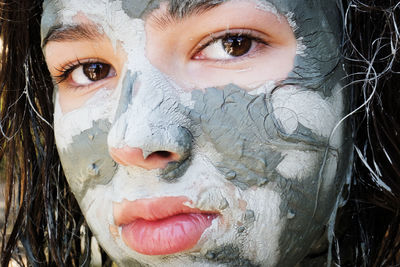 Close-up portrait of girl with facial mask on face