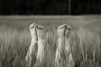 Low section of woman on field
