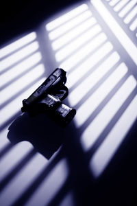 High angle view of camera on table by window