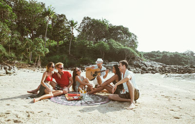 Group of people sitting on beach