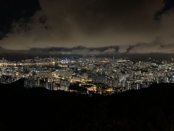 High angle view of illuminated cityscape against sky at night