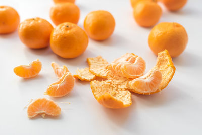 High angle view of orange fruits on white background