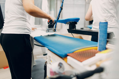 Midsection of man exercising in gym