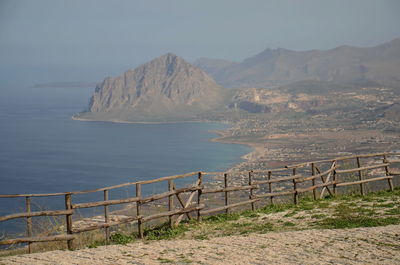 Scenic view of sea and mountains against sky