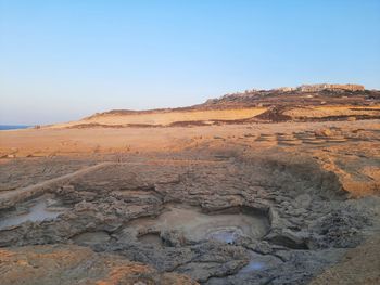 Scenic view of arid landscape against clear sky