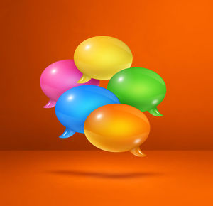 Close-up of multi colored balloons against orange background