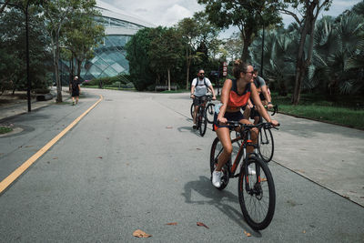 Man riding bicycle on road in city