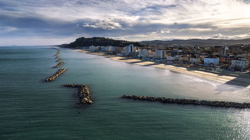 High angle view of sea and buildings against sky