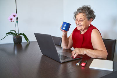 Young woman using mobile phone at home