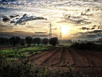 Agricultural field against sky during sunset