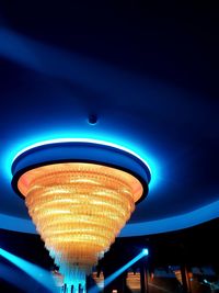 Low angle view of illuminated lights against blue sky