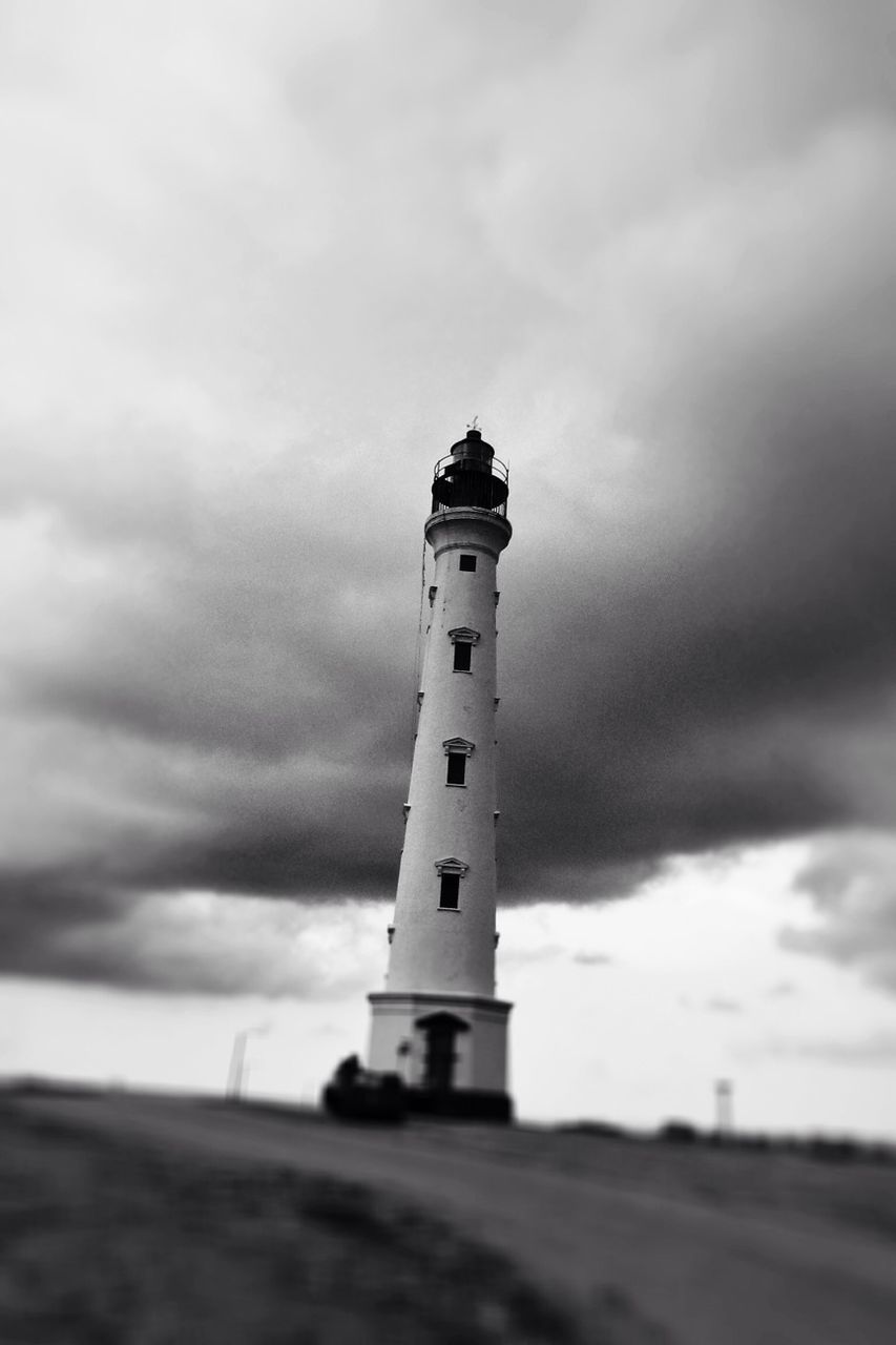 lighthouse, sky, guidance, cloud - sky, architecture, built structure, building exterior, cloudy, direction, protection, safety, security, low angle view, cloud, tower, weather, overcast, day, outdoors, nature