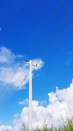 Low angle view of cables against blue sky