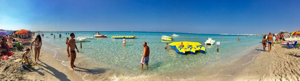 Panoramic view of beach against clear blue sky