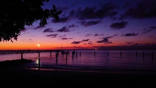 Pier on sea at sunset