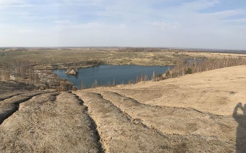 Panoramic view of land against cloudy sky